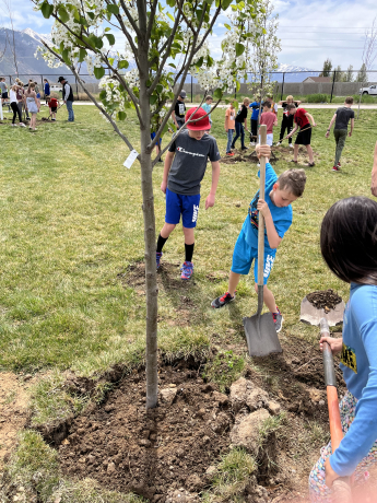 students planting trees for arbor day