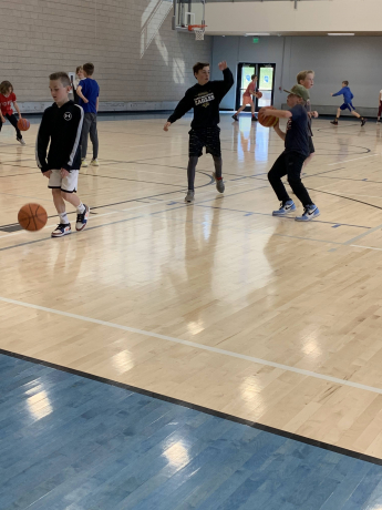 fifth grade students playing basketball at the orem rec center