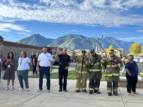 Our Principal and Spanish Fork firefighters help welcome students to school