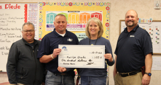 Mrs. Diede holding a check for her grant