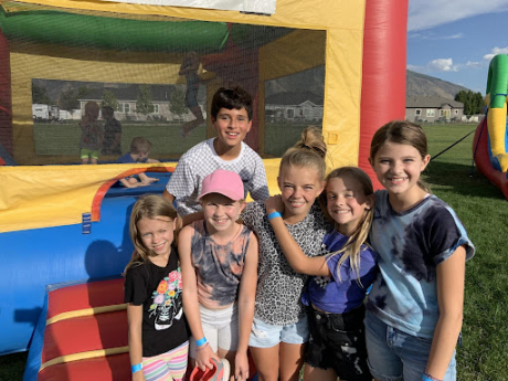 students posing outside the bouncy house