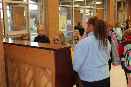 Ms. Laura Brockbank playing the piano for students