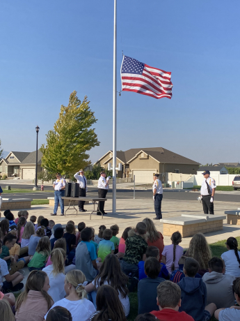 students learning about the flag ceremony from our Veterans