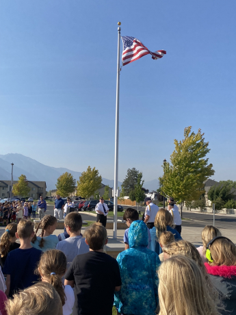 students learning about the flag ceremony from our Veterans