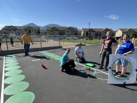 BYU faculty painting on the playground