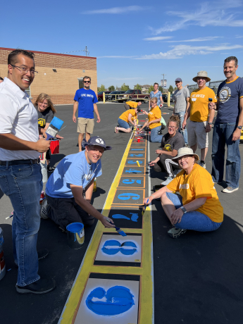 BYU faculty painting on the playground