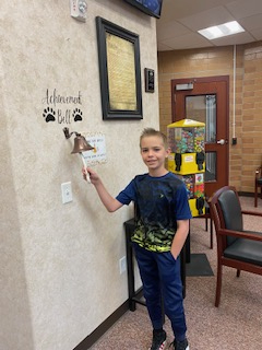 student ringing the achievement bell