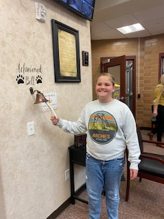 student ringing the achievement bell