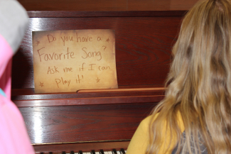 Ms. Brockbanks sign to ask students what their favorite song is